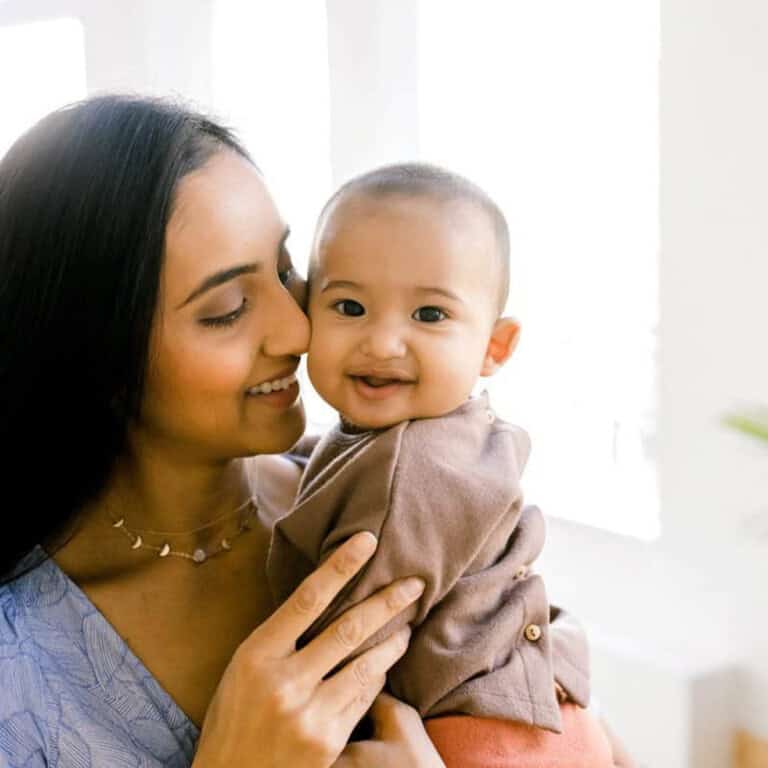 Mama with long black hair holding a 7 month old baby boy