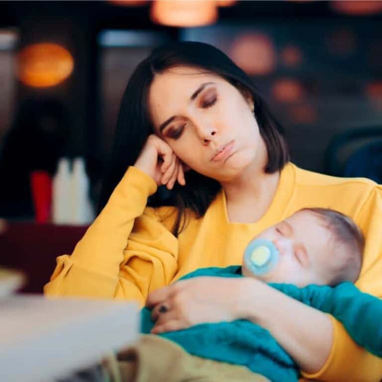 tired mom holding baby